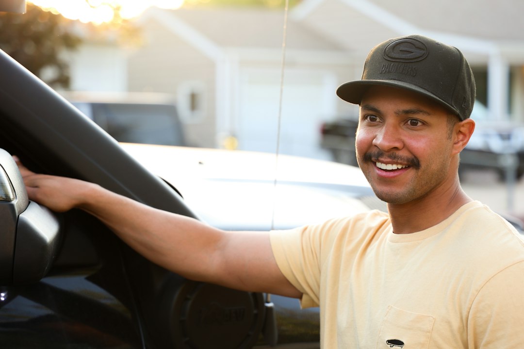 Satisfied homeowner smiling at their residential property